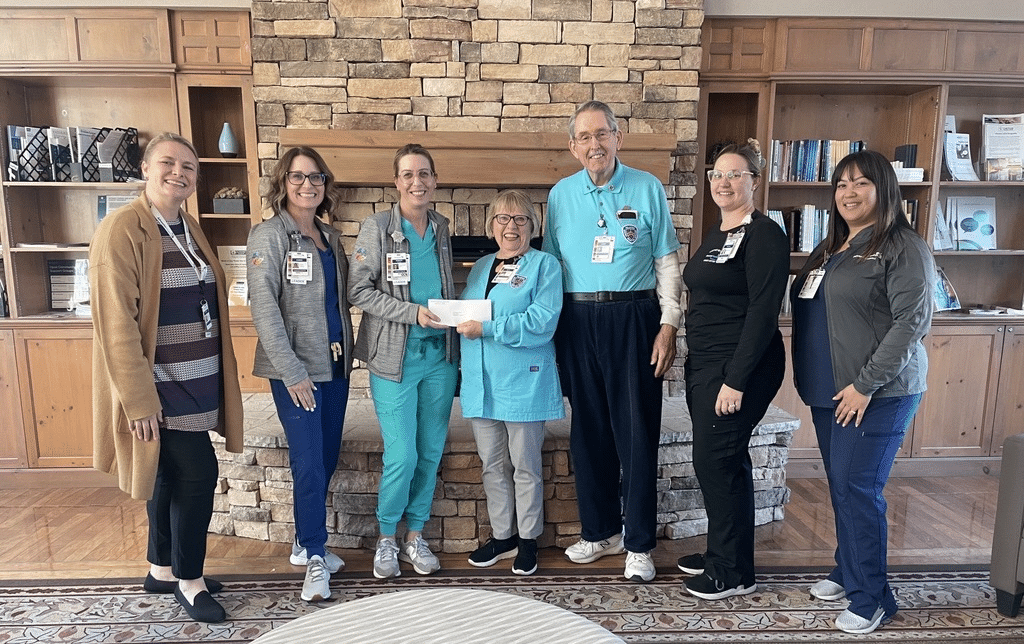 The Rideout Auxiliary presents a check to Cancer Center representatives.